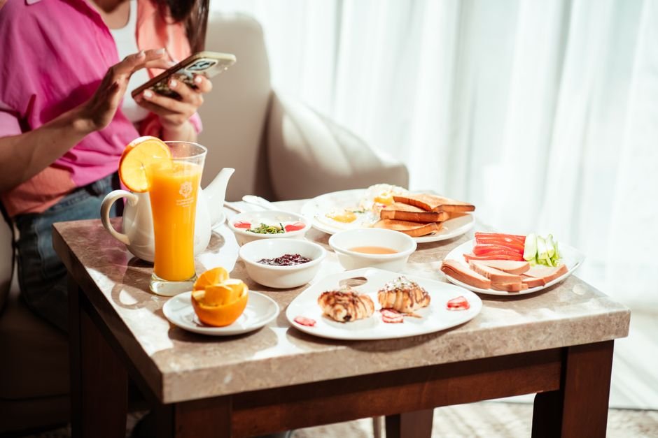 A vibrant breakfast spread with juice, bread, and fruits in a hotel setting, Baghdad.